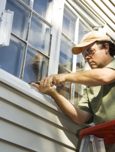 handyman caulking a house